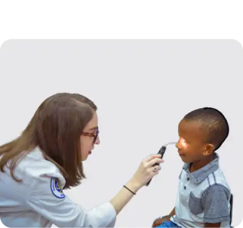 A doctor does a pupil reflex exam of a child's eye.