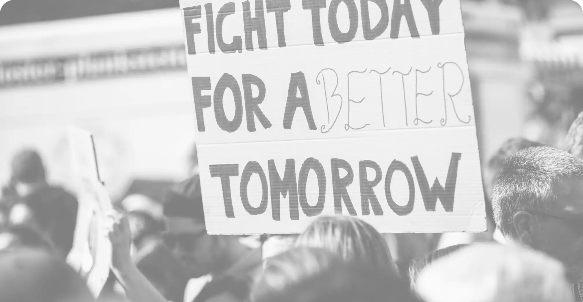 Marcher holding a sign stating "Fight today for a better tomorrow."