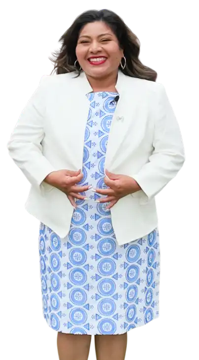 Businesswoman in a white blazer and blue-and-white patterned dress.