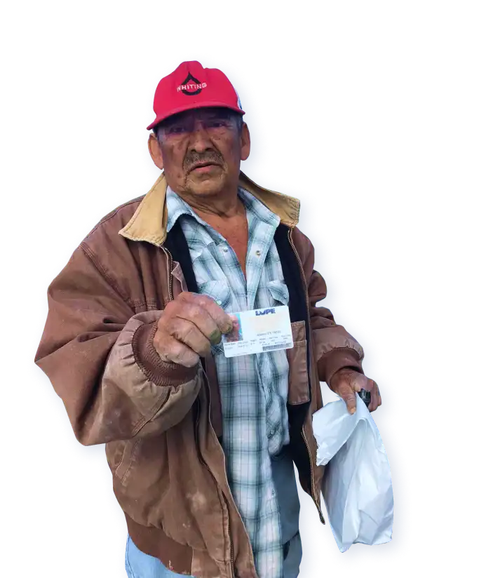 Aged Texas farmworker presenting his ID card.